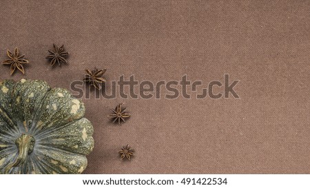 Halloween pumpkin and aniseed on wooden background flat lay
