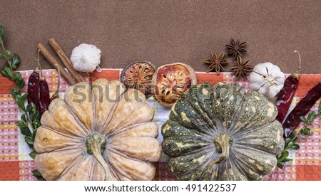 Halloween pumpkins spices chili peppers and onion flat lay
