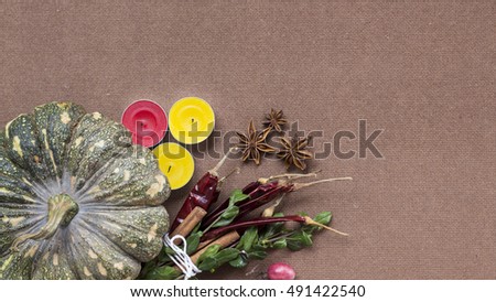 Halloween pumpkin, spices and candles wooden background flat lay