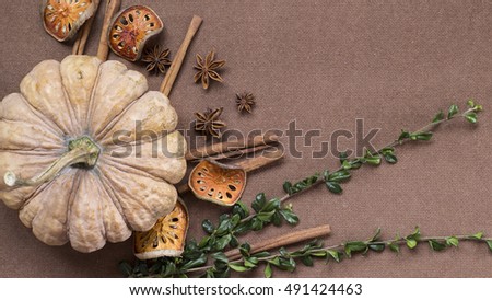 Halloween pumpkin and herbs background flat lay