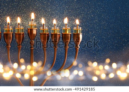 Low key Image of jewish holiday Hanukkah background with menorah (traditional candelabra) and burning candles and glitter overlay Royalty-Free Stock Photo #491429185