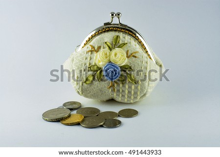 Coin purse and coins on white background

