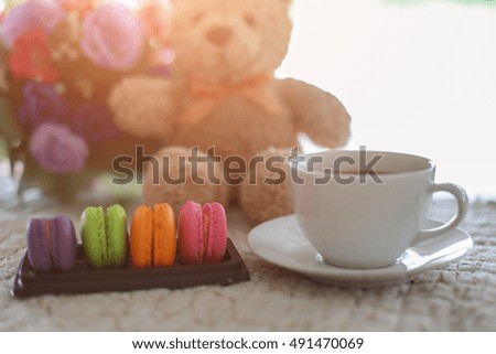 valentine macaroons with coffee on wooden table. Toned image