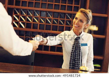 Picture of receptionist giving key card