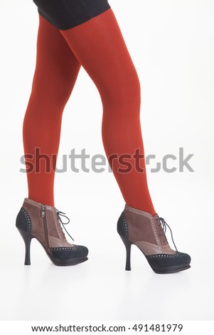 Woman's legs in shoes on isolated background