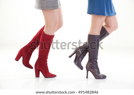 Woman's legs in shoes on isolated background