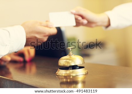 Picture of guests getting key card in hotel