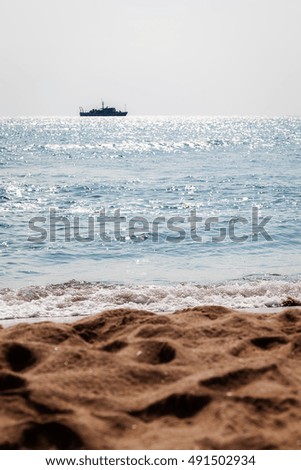Sandy beach and ship
