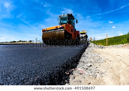 Close view on the road roller working on the new road construction site Royalty-Free Stock Photo #491508697