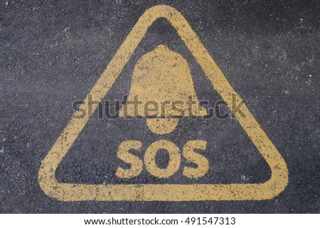 SOS sign painted on the road