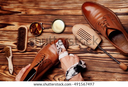 Shoes master polishing shoes with cloth (bull shoes)(Glacage).shoes shining.top view Royalty-Free Stock Photo #491567497