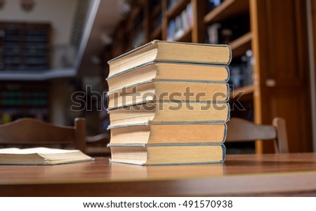 piles of books in library hall (Shallow depth of field)