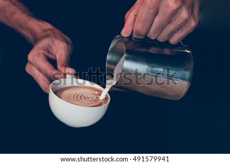 Pouring milk making coffee latte art,retro color tone