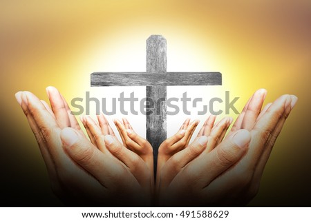 Hands bless the cross in the sky. symbolic representing Jesus