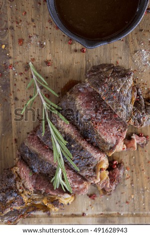 meat and rosemary on wood