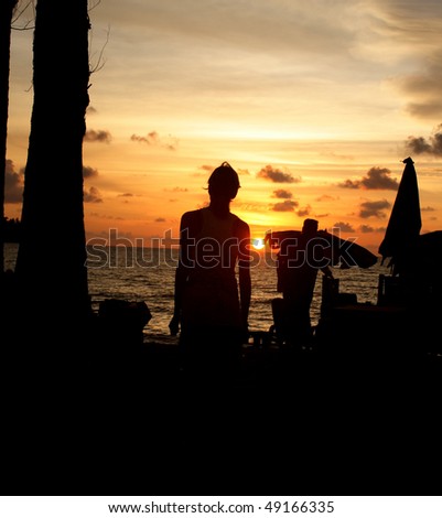 Woman or girl as silhouette in sunset