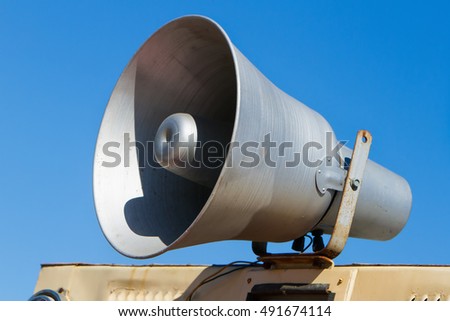 Old megaphone on background of sky, speaker loudspeaker