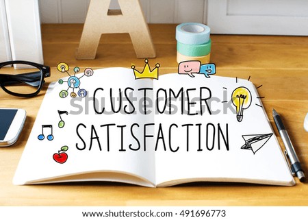 Customer Satisfaction concept with notebook on wooden desk 

