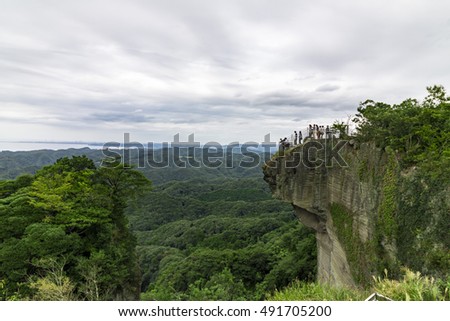 tourists on sheer cliff
