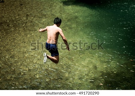 The man Jumping into the waterfall