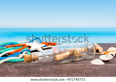 Tropical sea seen from the boat. Message in bottle on table