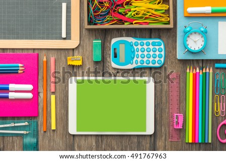 Back to school and technology banner with digital touch screen tablet and colorful stationery