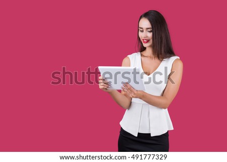 Smiling lady in white top looking at her tablet computer screen. Concept of surfing the net and modern technology. Mock up. 
