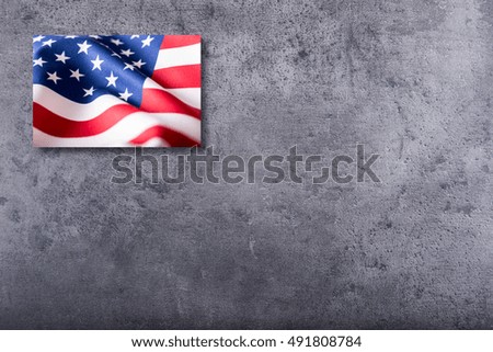 American flag on concrete background.