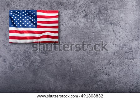 American flag on concrete background.