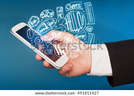 Hand holding phone with hand drawn speech bubbles concept