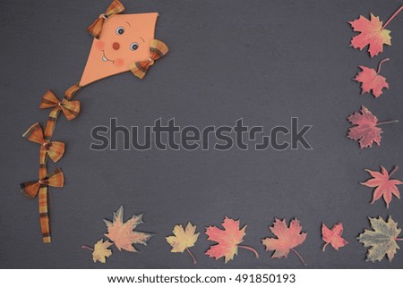 Blackboard with autumn leaves and kite