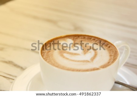 Defocused and blurred image for background of latte art with warm light in the morning