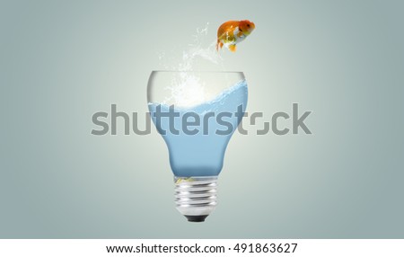 Goldfish jumping out light bulb