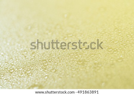 Pale golden background with drops.