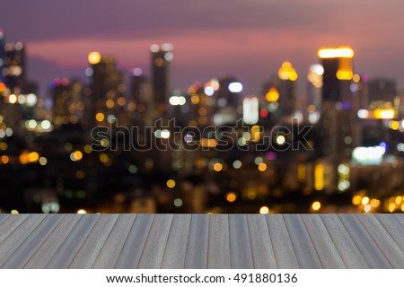 Opening wooden floor, abstract blurred lights night view, city office building 