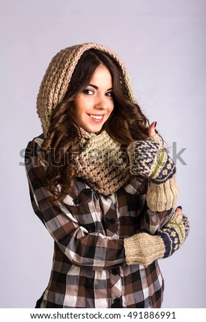 beautiful young girl wearing a scarf and gloves