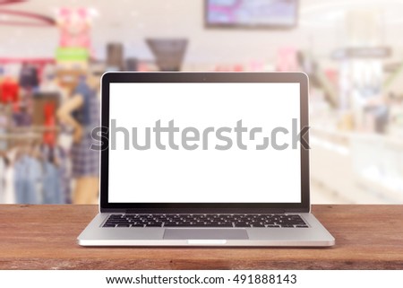 Laptop with blank screen on table. blurred background