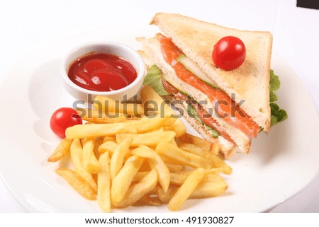 sandwich with french fries and sauce on plate