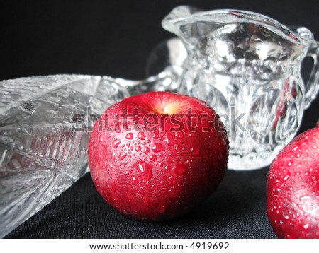 red apples and glass on black