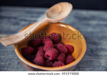 Raspberries on wooden old table