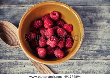 Raspberries on wooden old table