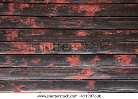 Old wooden boards with shabby red paint. Background with horizontal lines.