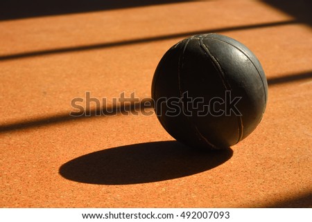 Basketball on a floor. Rigid sunlight from a window. Sports concept.
