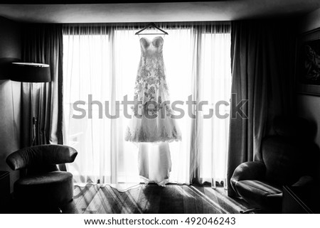 white drees for bride hagging in the room