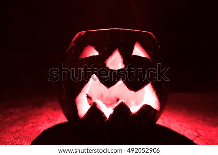 Scary Halloween pumpkins isolated on a black background. Red colored scary glowing faces trick.