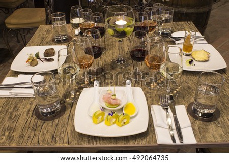 Served for a banquet table. Wine glasses with napkins, glasses and gourmet food. Picture taken in Peru. 