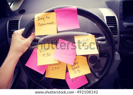 Steering wheel covered in notes as a reminder of errands to do Royalty-Free Stock Photo #492108142