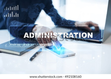 Businessman is working in office, pressing button on virtual screen and selecting "Administration". Business concept.