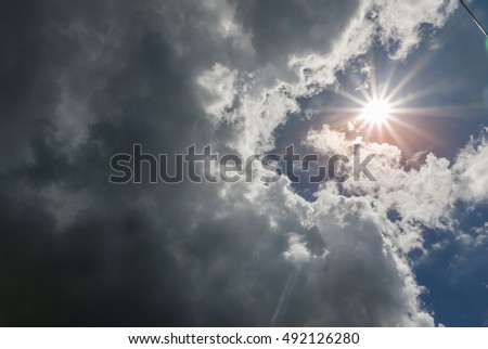 Rain Clouds in rainy season and the sun. Royalty-Free Stock Photo #492126280