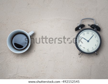 TOP VIEW SAND BACKGROUND WITH COFFEE  TIME TRAVEL CONCEPT
